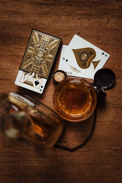 glass of whiskey and playing cards